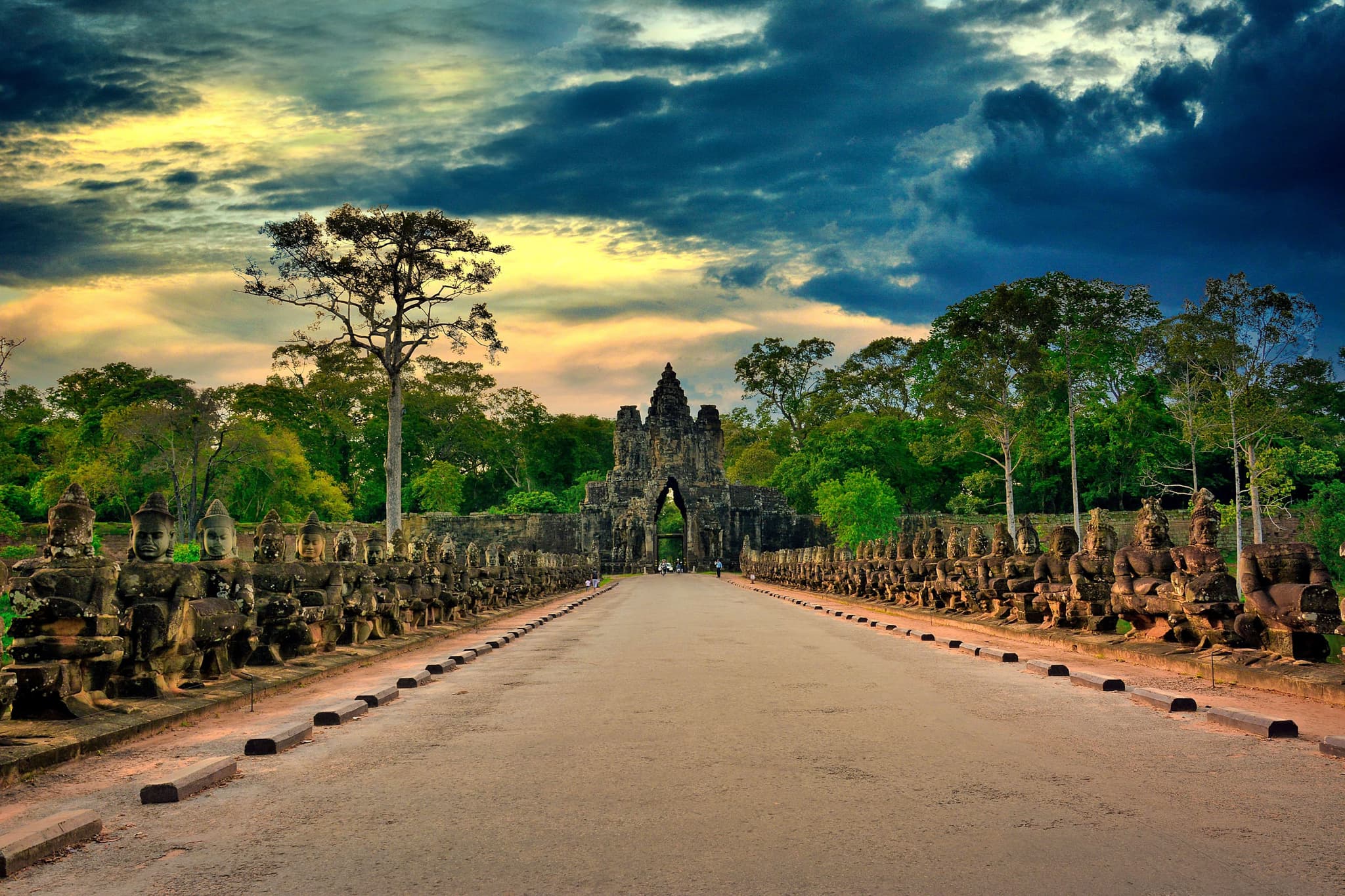 Stone causeway lined with guardian statues leading to the South Gate of Angkor Thom, Cambodia